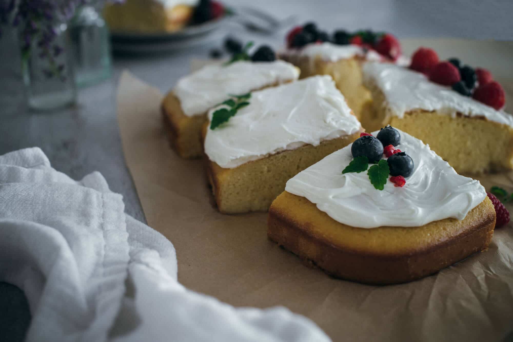 Slices of cake with icing and fruit