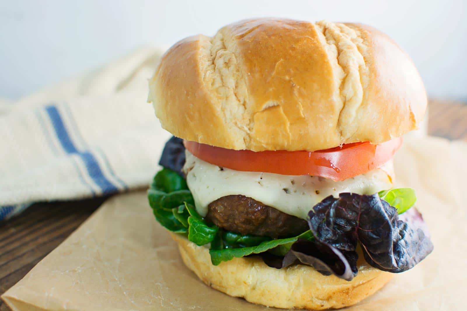 Harvarti, heirloom tomatoes and artisan lettuce top the best Flippin' Burger! Recipe @LittleFiggyFood