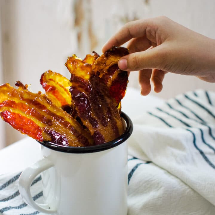 Enjoying candied bacon, an ideal tailgating recipe idea.