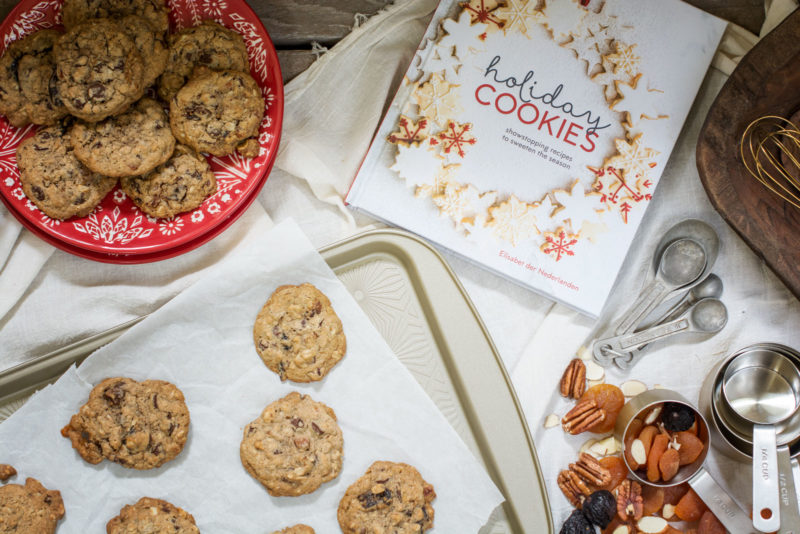 Holiday baking cookbook and a batch of cookies