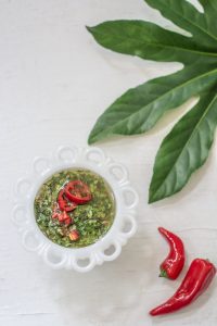 Chimichuri Recipe in a white bowl with red chili peppers