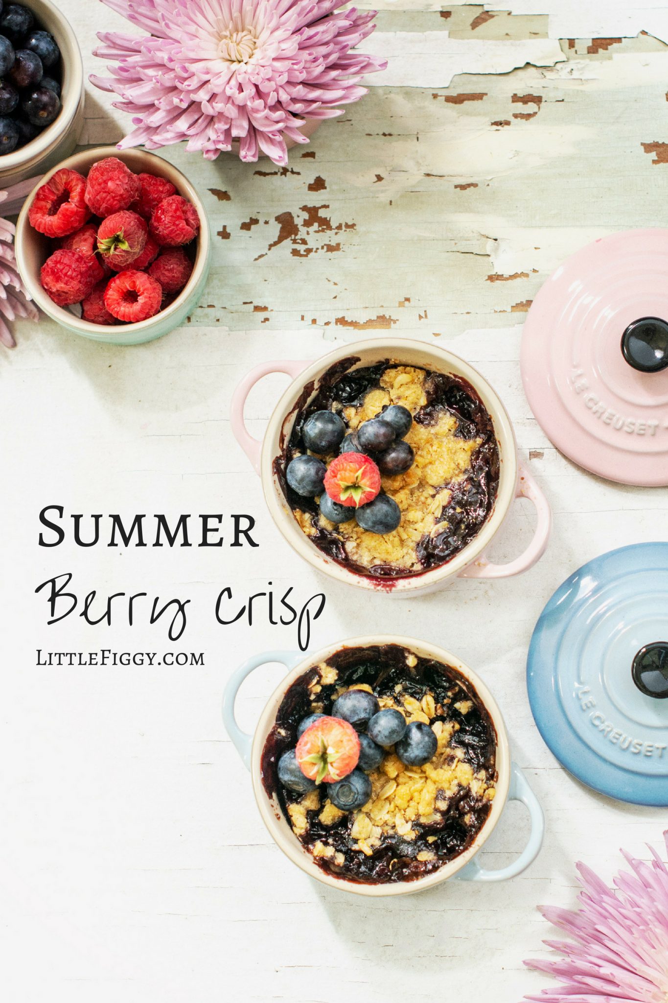 Summer berry crisp dessert in mini cocottes from Le Creuset, on a white background