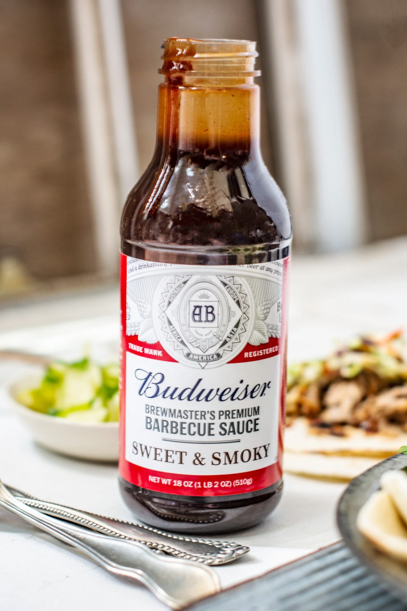 A bottle of Budweiser Brewmasters Sweet and Smoky BBQ Sauce