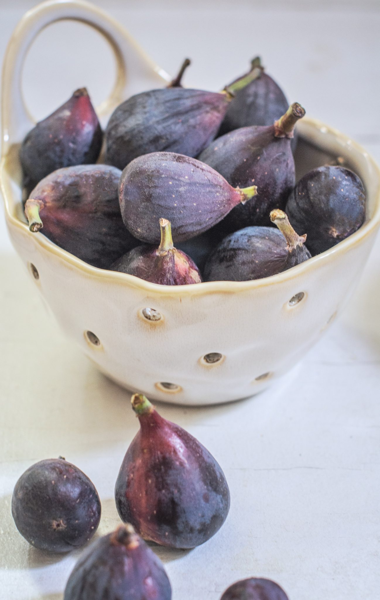 White bowl with fresh mission figs