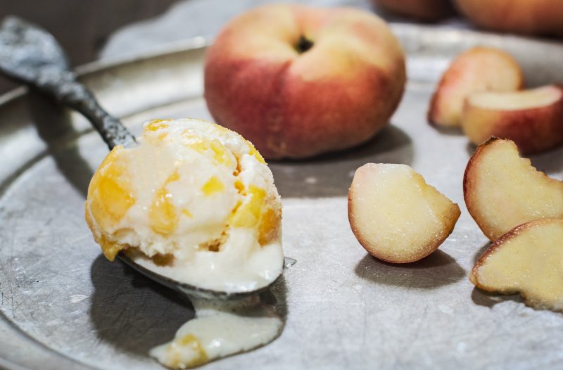 Homemade Peach Ice Cream on a spoon.
