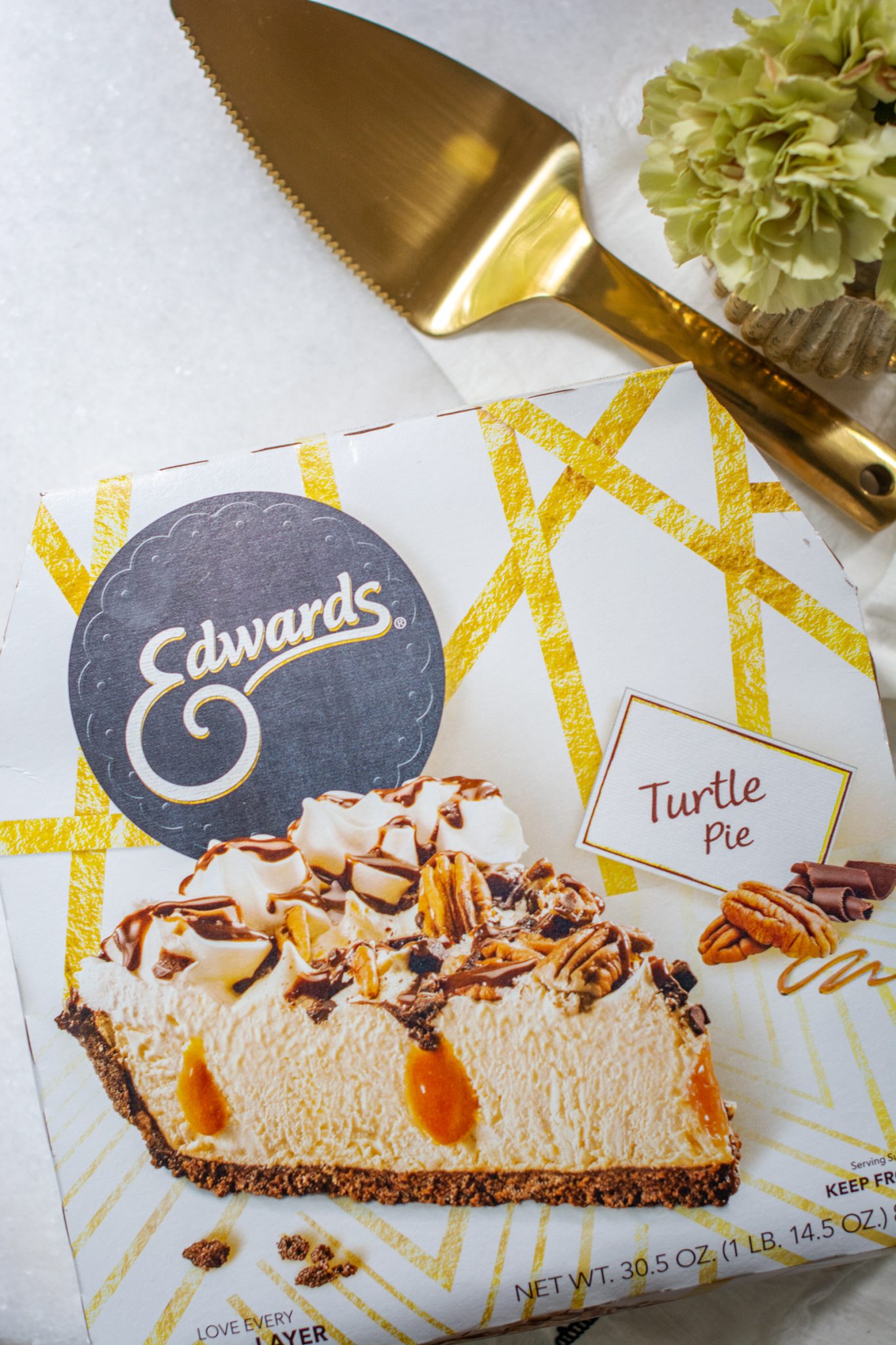 Edwards turtle pie package with gold pie slicer and flowers