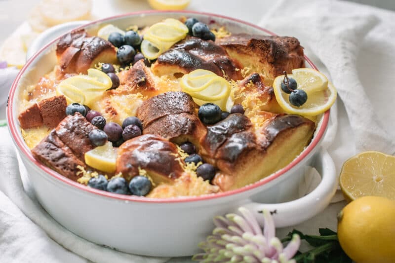 White dish with lemons and blueberries and dessert