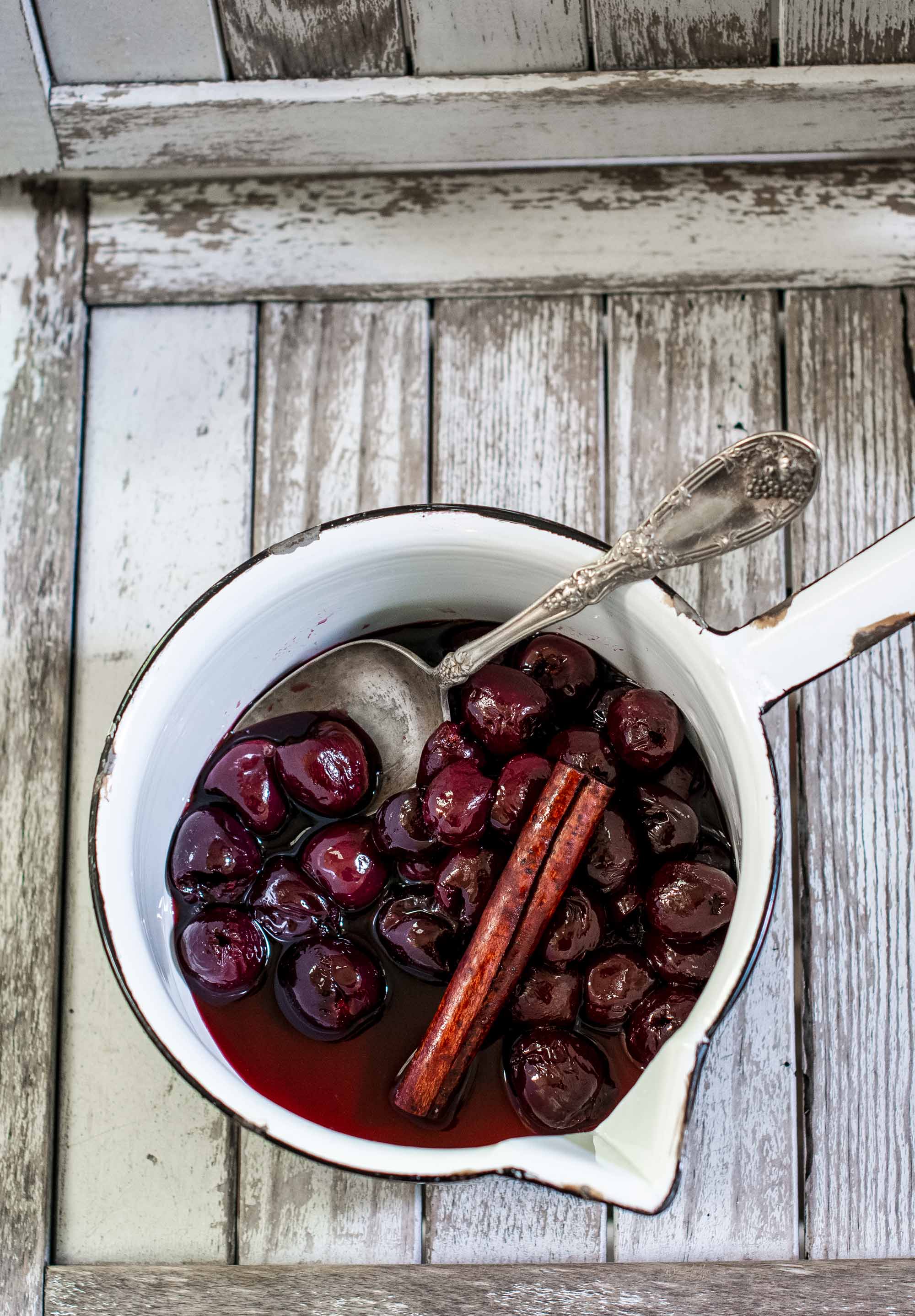 Maraschino Cherries with cinnamon stick in pot.