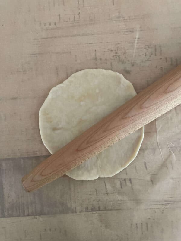 rolling out tortilla dough