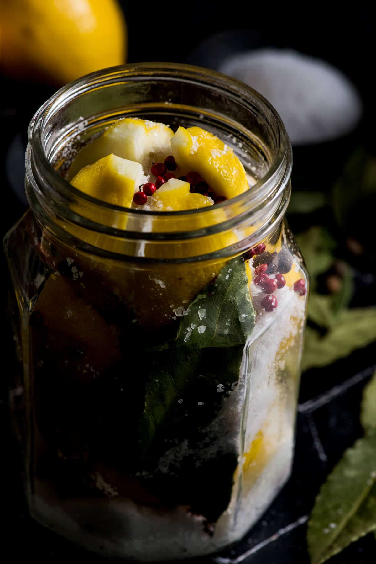 Lemons in Jar with salt bay leaves and peppercorns
