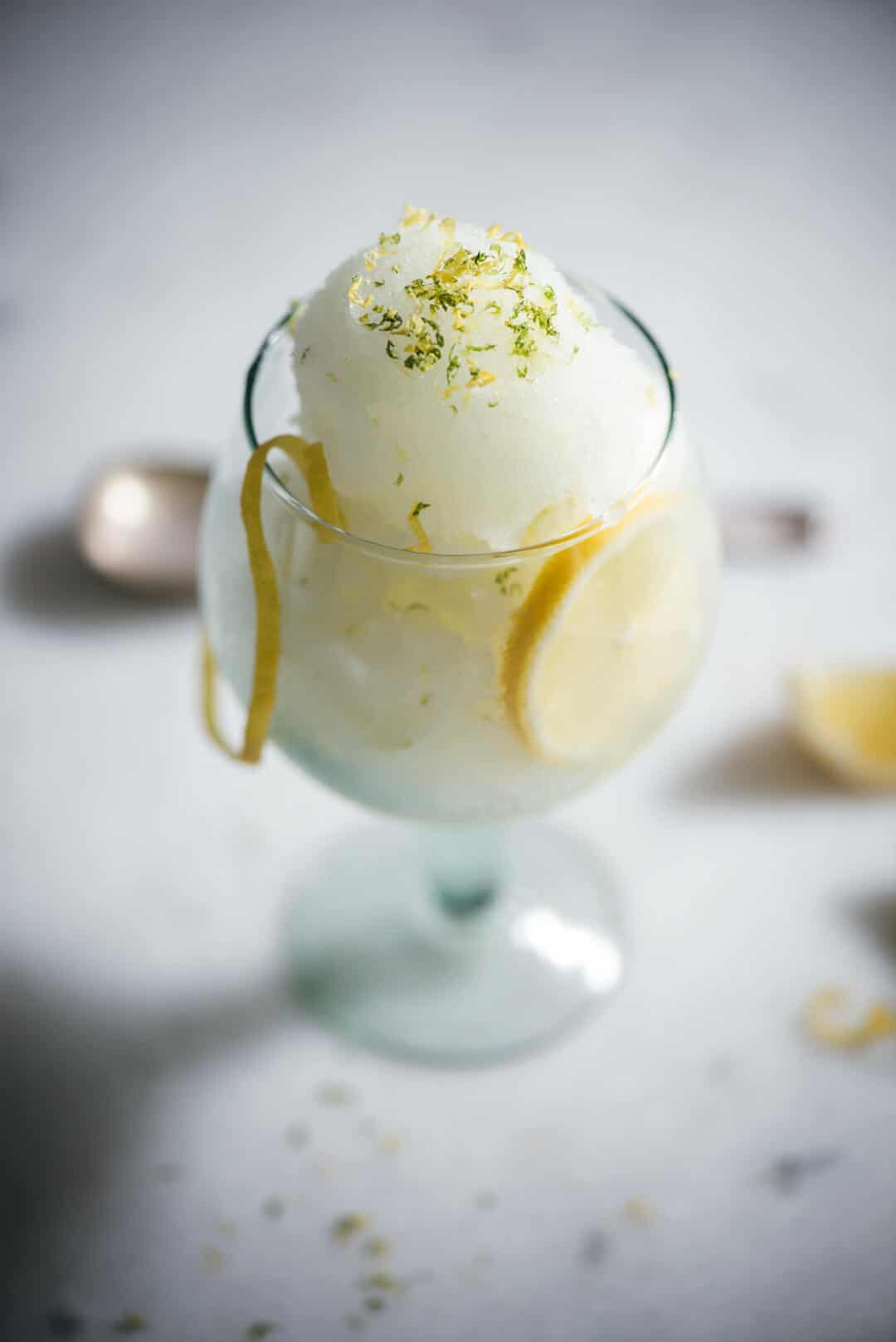 Gin and Tonic sorbet in a glass with lemon garnish