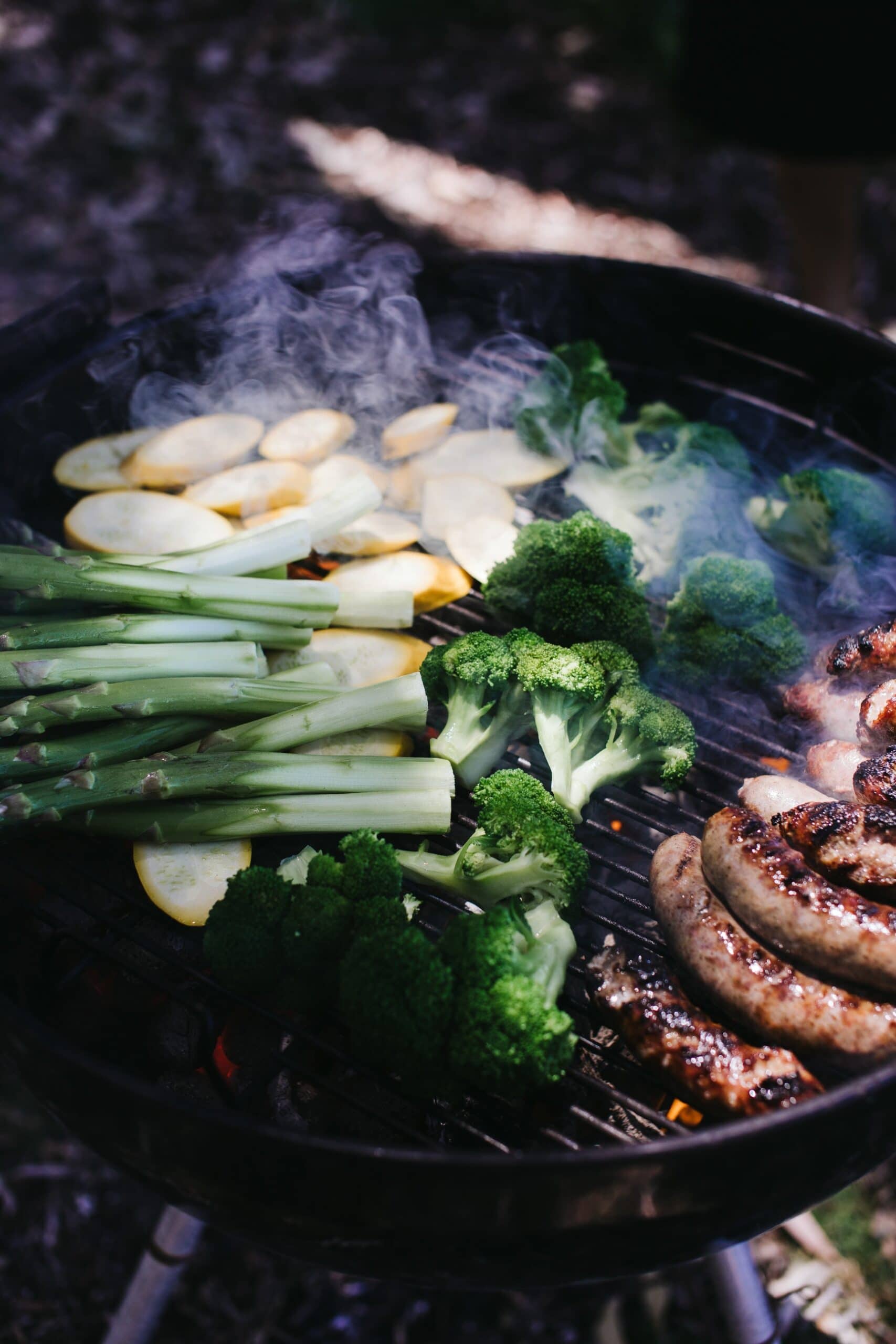 Vegetables and meat on a charcoal grill