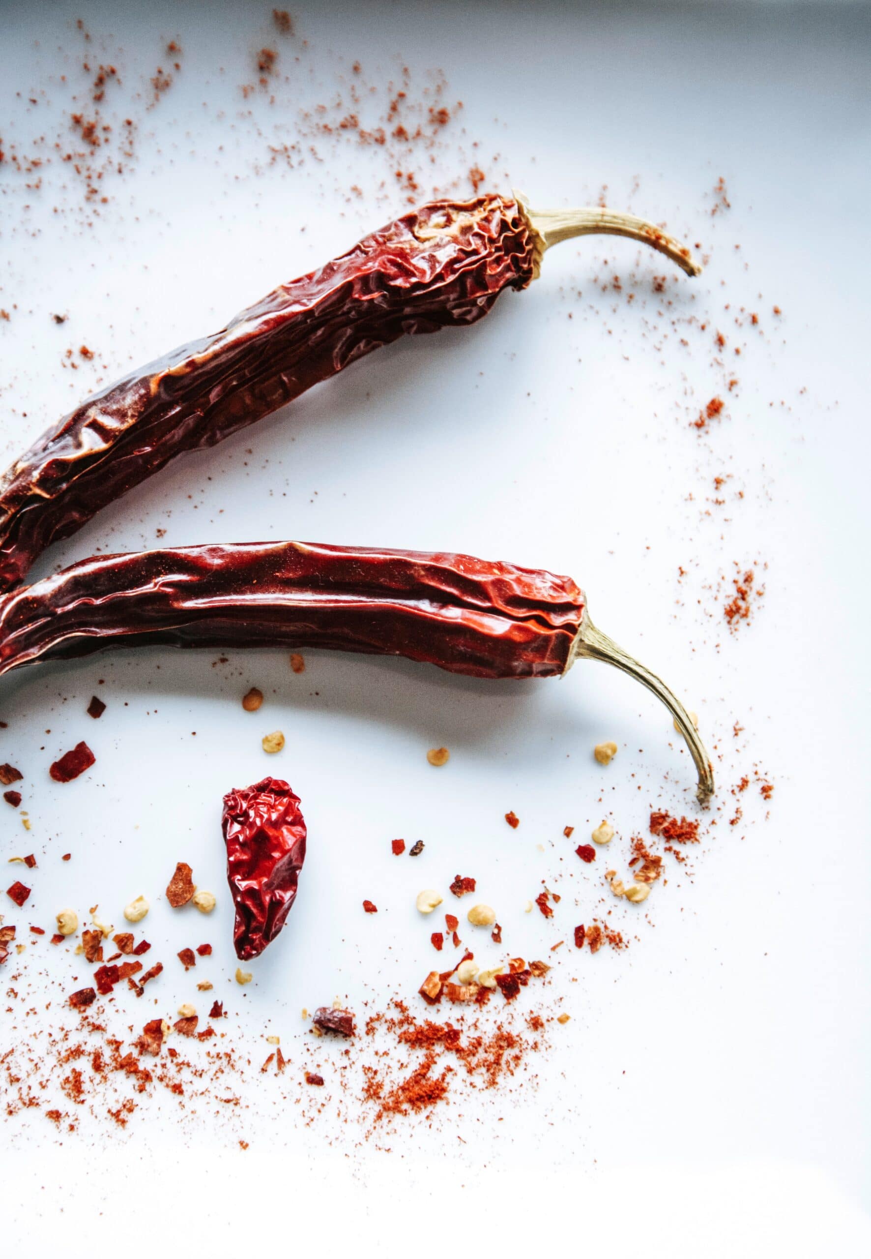 Must have spices in your pantry - chili peppers on white table